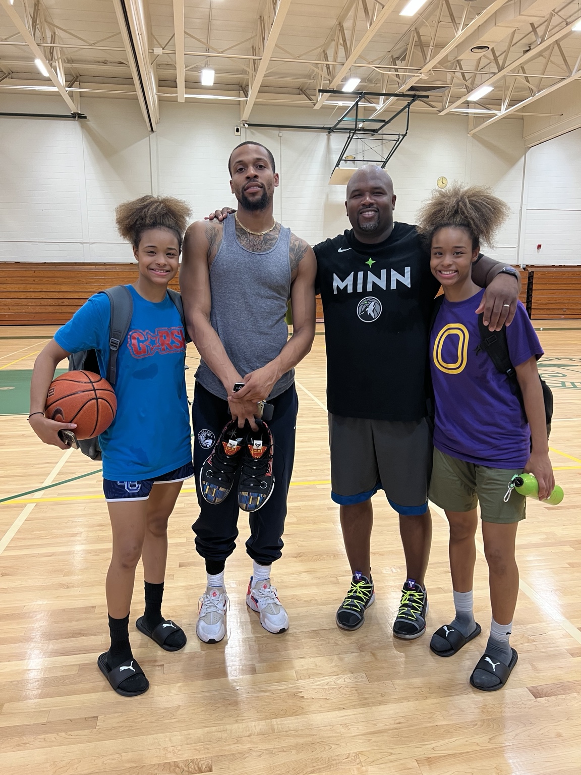 Coach Jamar Wise with an adult and two young players