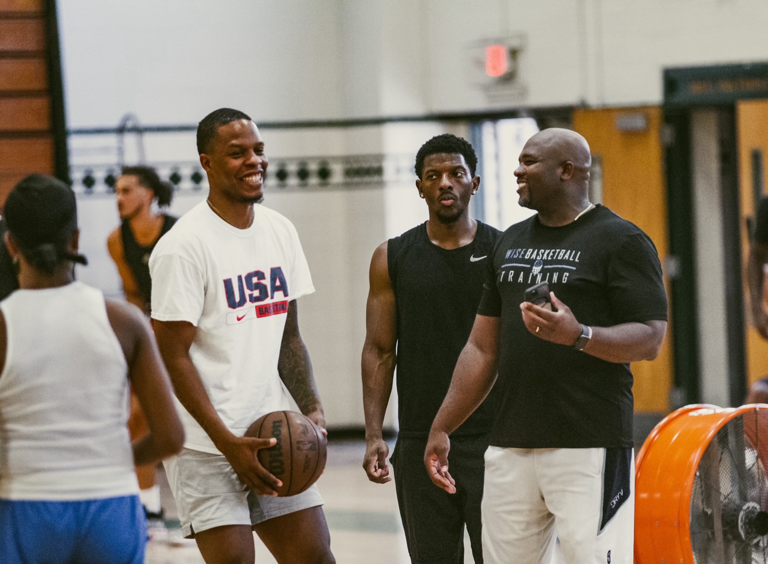 Coach Jamar Wise talking with athletes