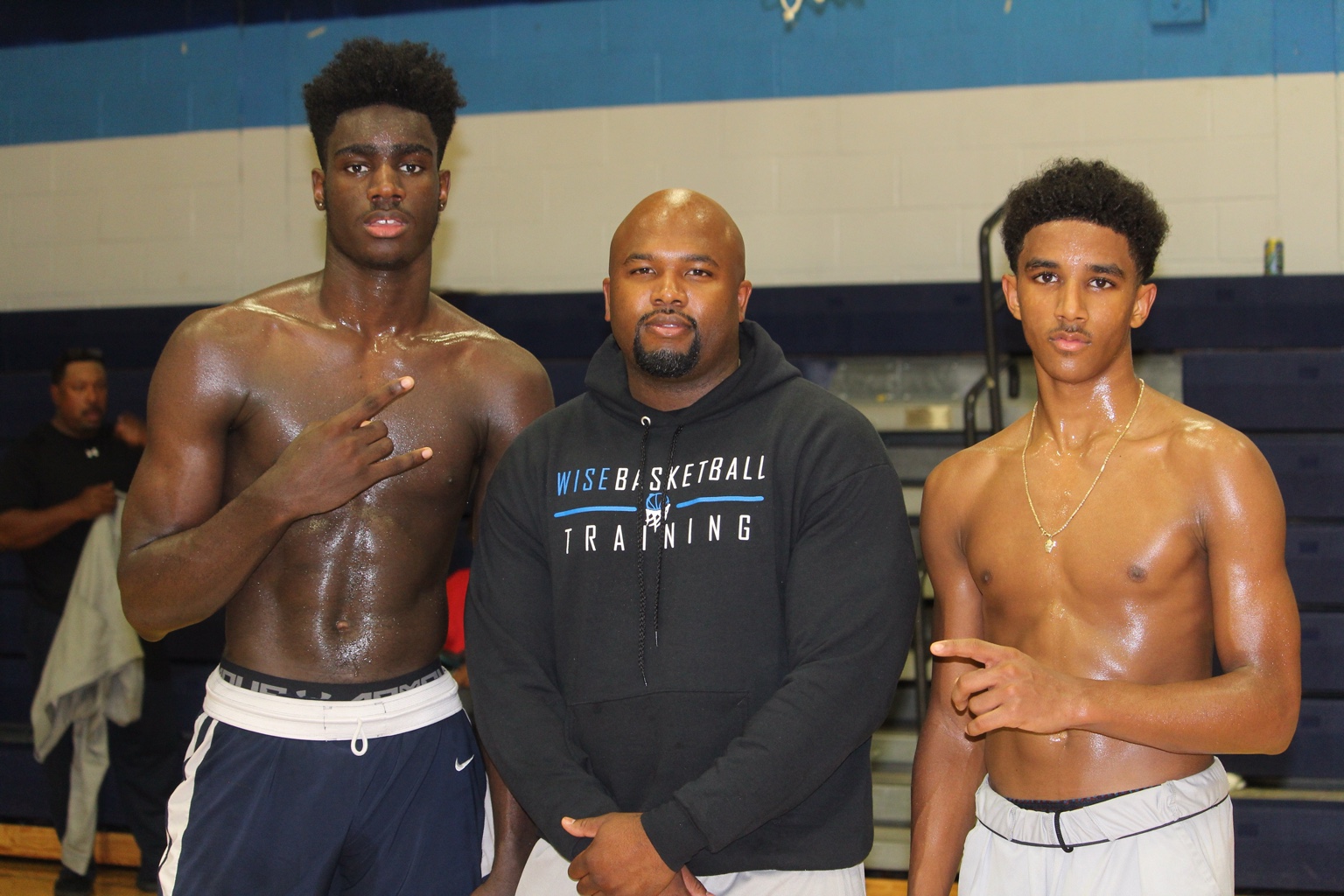 Coach Jamar Wise with two athletes