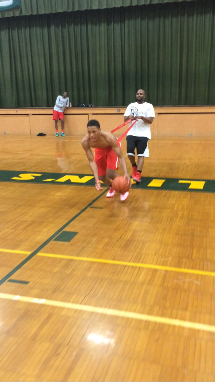 Player working on ball handling with a resistance band