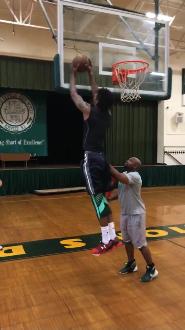 Player finishing at the basket during a workout